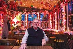 Bob Paganico, of the Spirit of Christmas, sits in his bar Bob’s Garage Restaurant and Lounge. - PHOTO BY THEO SCHWARZ