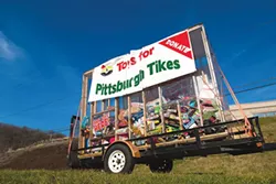 The Toys for Pittsburgh Tikes donation trailer sits outside of Jaden’s Catering on Route 22 in Monroeville. - PHOTO BY THEO SCHWARZ