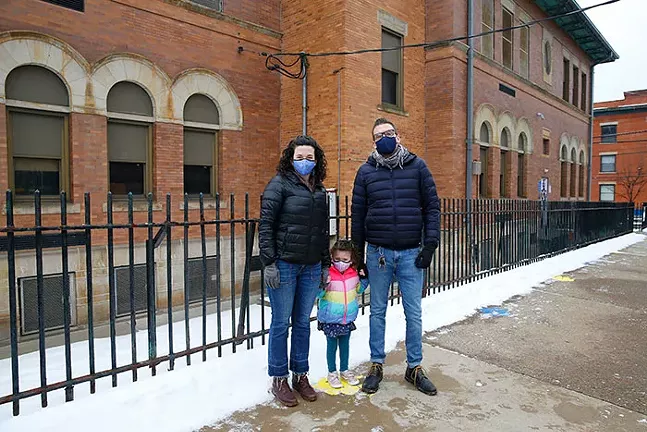 Andrea Weinstein, Tim Verstynen, and their daughter Skylar Weinstein pose for a portrait outside of Woolslair Elementary School in Lawrenceville. - CP PHOTO: JARED WICKERHAM