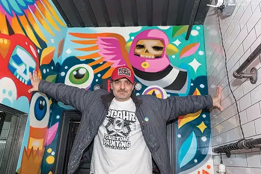 Painter Matt Spahr with one of his commissioned murals inside Downtown’s Tako restaurant - PHOTO BY AARON WARNICK