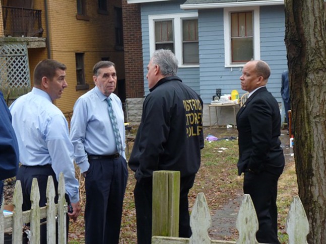 Officials meet outside the scene of a mass shooting in the Pittsburgh suburb of Wilkinsburg on March 10. - PHOTO BY REBECCA NUTTALL