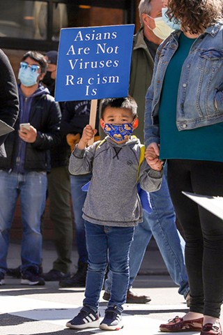 A young person holds up a sign during a Stop Asian Hate protest in Oakland on Sat., March 20. - CP PHOTO: KAYCEE ORWIG
