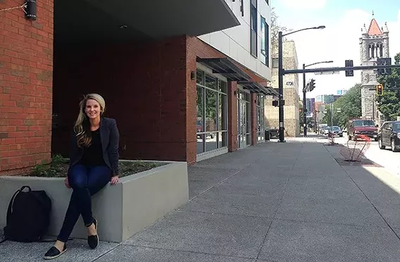 Rachel Reilly Carroll outside the Penn-Mathilda apartments, a new affordable-housing complex. - PHOTO BY RYAN DETO