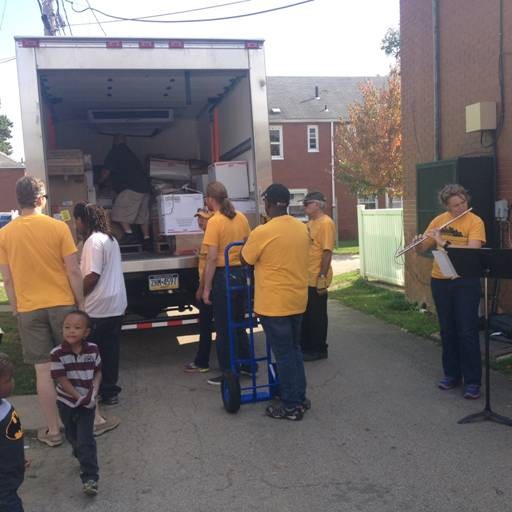 Striking PSO musicians unload a truck of food from 412 Food Rescue at Hawkins Village as two fellow members play soothing chamber music for residents. - CP PHOTO BY STEPHEN CARUSO