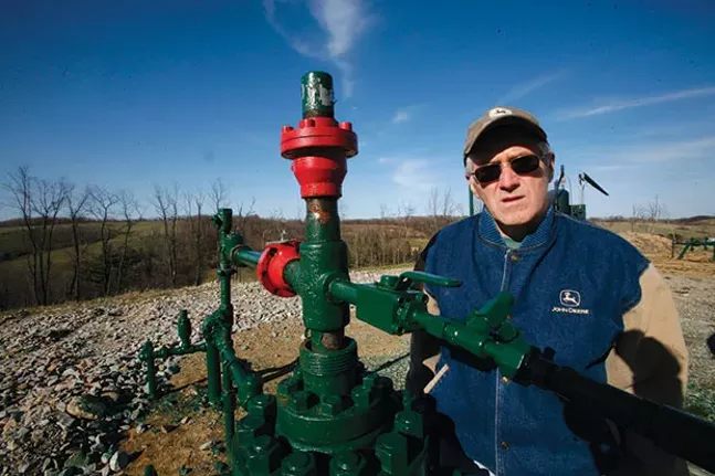 Ron Gulla stands at the site of one of four natural-gas wells on his property in Hickory, Pa. in 2009 - CP FILE PHOTO