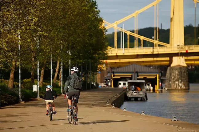 Cyclists on the Three Rivers Heritage Trail in Pittsburgh's North Shore in May - CP PHOTO: JARED WICKERHAM
