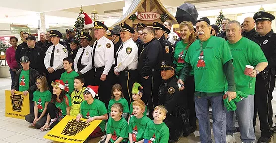Jimmy Cvetic, right, and members of several local police departments will be distributing toys this week. - CP PHOTO BY KIM LYONS