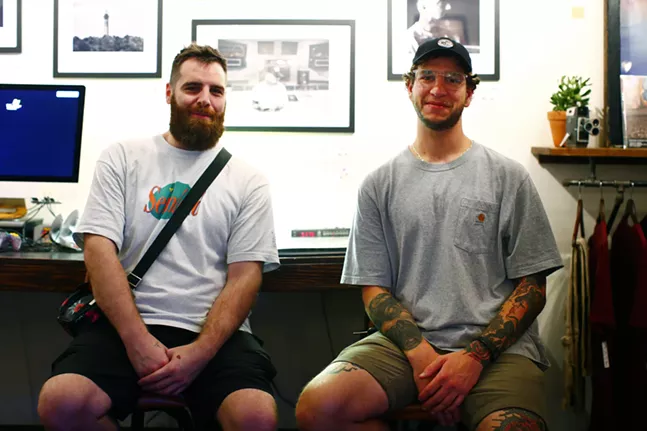 Photographer Justin Boyd (left) and Pat Bruener (right), owner of Bankrupt Bodega, pose for a portrait during Proper Nouns, a photography show by Justin Boyd, at Bankrupt Bodega. - CP PHOTO: JARED WICKERHAM