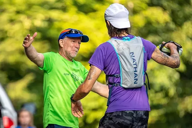 Greg Brunner embraces his dad at aid station number 3 during mile 16 of the Baker Trail Ultra Challenge. - CP PHOTO: KAYCEE ORWIG