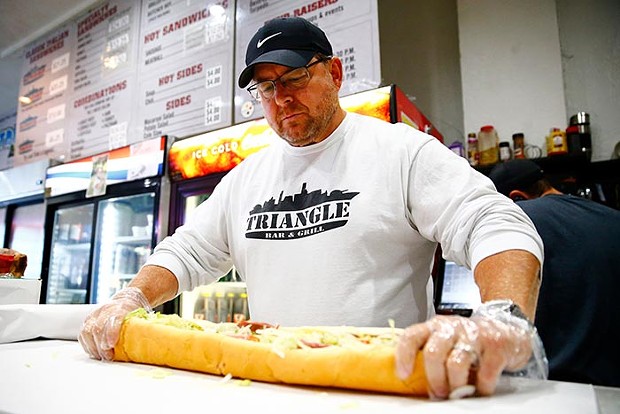 Tom Crombie, owner of Triangle Bar and Grill, makes a battleship sub. - CP PHOTO: JARED WICKERHAM