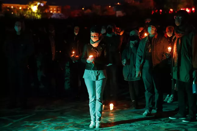 People gather, light candles, and share stories as they mourn the loss of Nique Craft at the color park in the South Side on Fri., Nov. 5, 2021. - CP PHOTO: JARED WICKERHAM