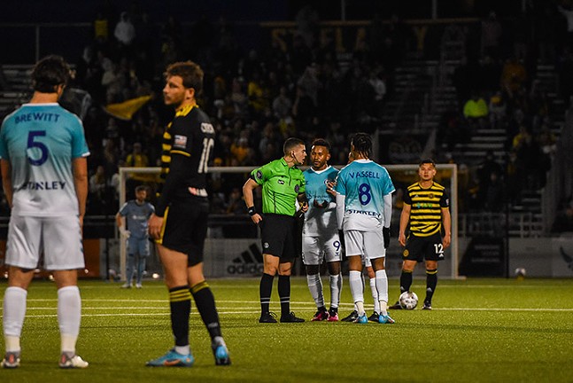 A referee speaks to Hartford Athletic players after pulling a yellow card at Highmark Stadium. - CP PHOTO: PAM SMITH