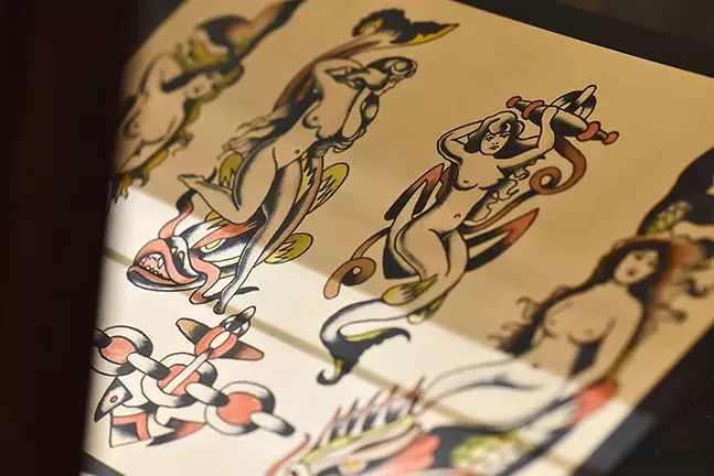 What are American Traditional tattoos? - - American Traditional, also called “Old School,” is a tattooing style featuring bold black lines and highly saturated solid blocks of mostly primary colors. The designs are usually relatively simple and two-dimensional. Unlike more realistic styles, American Traditional tattoos are supposed to look like drawings. Because American Traditional was so ubiquitous for so long, according to the website Tatt Mag (tattmag.com), it didn’t even need a name until much later when new styles began to develop. - CP PHOTO: PAM SMITH