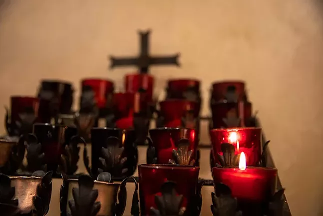 Prayer candles burn in the back of St. Bede’s of Saint Mary Magdalene Parish. - CP PHOTO: KAYCEE ORWIG