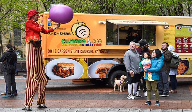 O'Ryan the O'Mazing performs to onlookers by the Cilantro & Ajo food truck during Pittsburgh Opens on Thu., April 21. - CP PHOTO: PAM SMITH