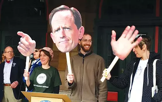 Protesters holding a puppet made by Squonk Opera's David Wallace, at the Feb. 21 Tuesdays with Toomey protest at Station Square - CP PHOTO BY REBECCA ADDISON