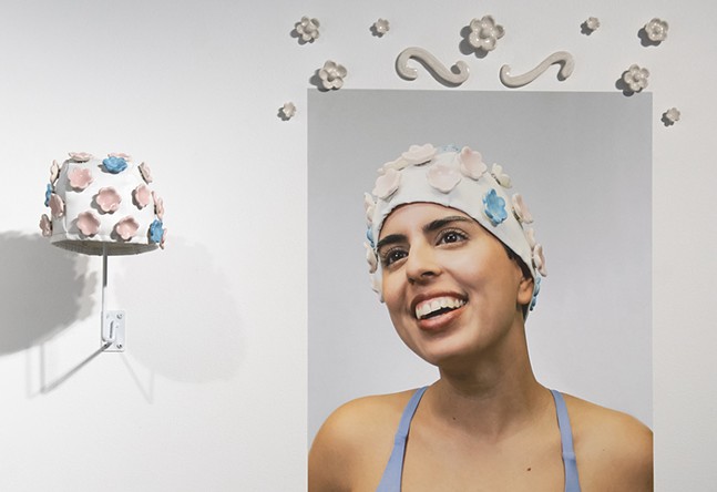 Swim cap with ceramic flowers is displayed next to a photo of a woman joyfully wearing the cap.