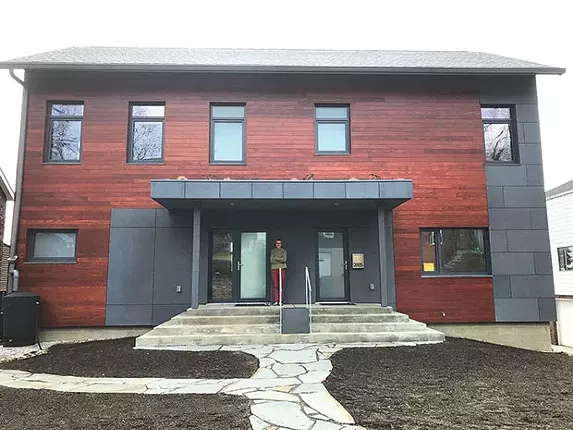 Lucyna de Barbaro on the front step of her new passive house, in Squirrel Hill - CP PHOTO BY BILL O'DRISCOLL