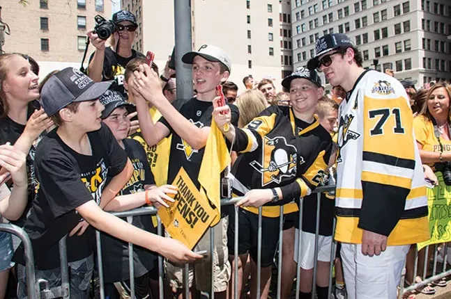 Evgeni Malkin poses with fans during the Penguins’ 2017 Stanley Cup parade. - CP PHOTO BY JORDAN MILLER