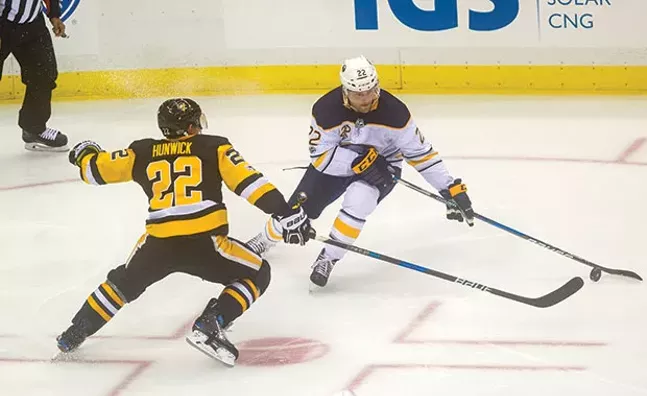 Matt Hunwick battles with Buffalo Sabres Johan Larsson on Sept. 27 at PPG Paints Arena. - CP PHOTO BY VINCENT PUGLIESE
