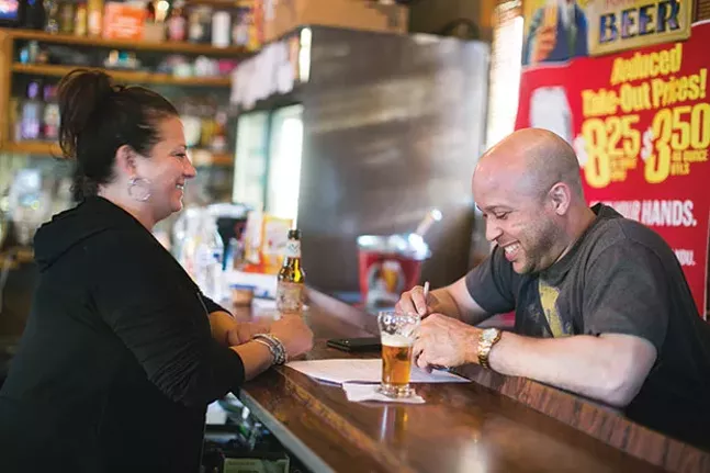 DeeDee, a bartender at Howard’s for 15 years, shares a laugh with a customer - CP PHOTO BY JOHN COLOMBO