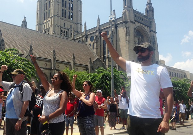 Activist Jasiri X (right) and others protested Sunday outside of East Liberty Presbyterian Church - CP PHOTO BY RYAN DETO