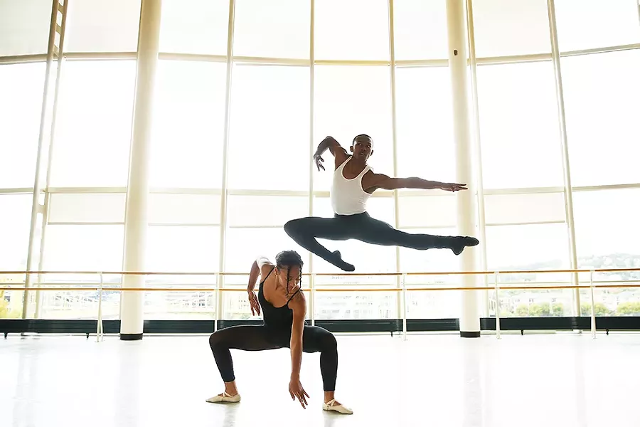 Lexis Wright, a senior at CAPA, and Jau’mair Garland, a junior, dance together with a view of the sister bridges in the background at CAPA school. - CP PHOTO: JARED WICKERHAM