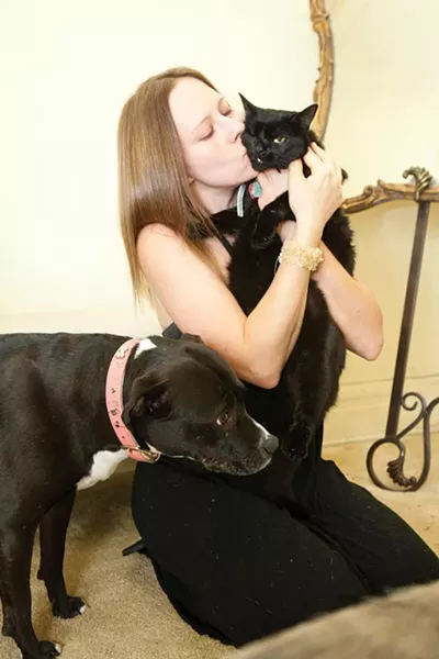 Heather Long kisses her one-eyed rescue cat named Frankencat - PHOTO BY HEATHER MULL