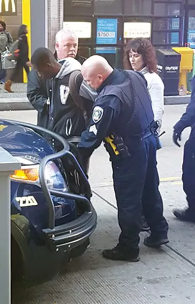 Salat Abdalla being arrested outside Wood Street T Station - PHOTO BY REBECCA NUTTALL