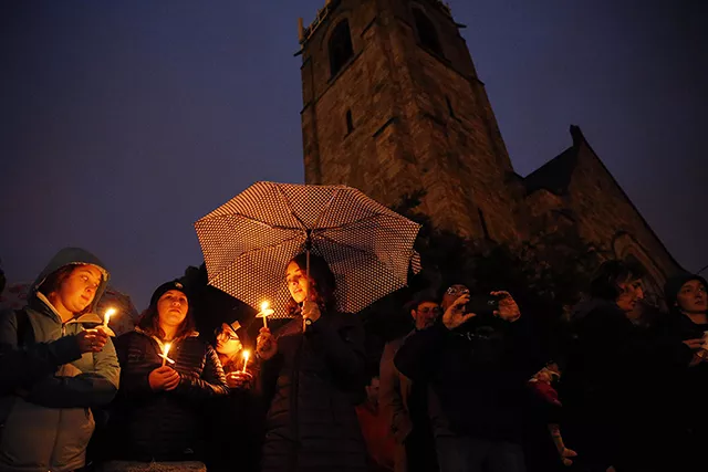 People lit candles while attending an interfaith vigil at Sixth Presbyterian Church in Squirrel Hill. - CP PHOTO: JARED WICKERHAM