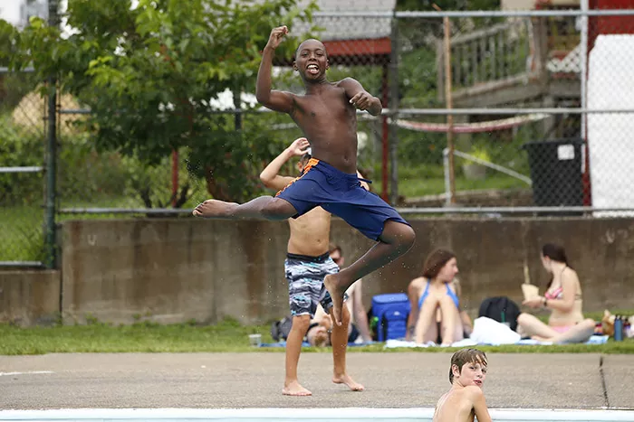 Jordan, 11, jumps into the Bloomfield pool while posing for the camera - CP PHOTO: JARED WICKERHAM