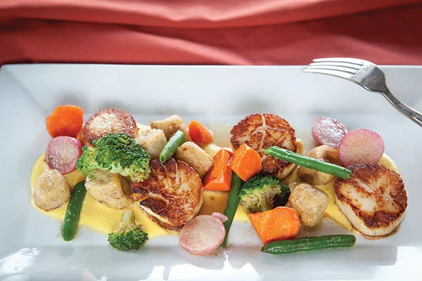 Seared scallops with house-made potato gnocchi and summer vegetables in honey-corn cream sauce - PHOTO BY HEATHER MULL