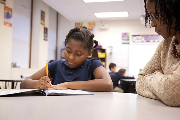 LaShawn Neal works with a student at Propel East - PHOTO BY HEATHER MULL