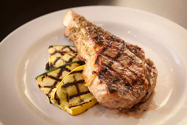 Char-grilled veal chop with rosemary au jus - PHOTO BY HEATHER MULL