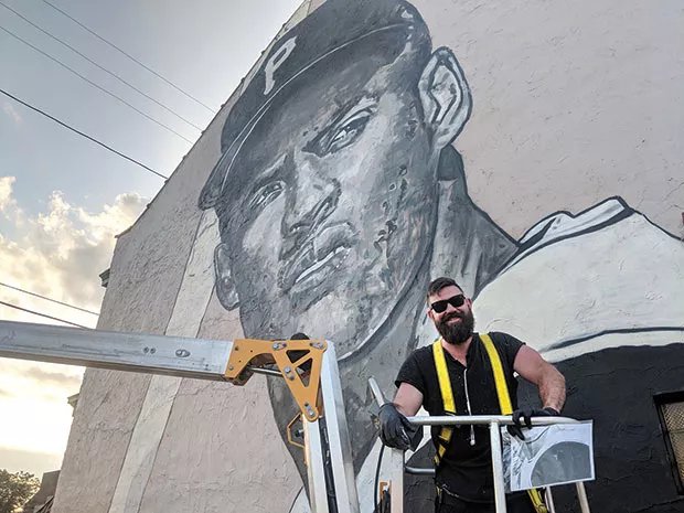 Jeremy Raymer in front of his Roberto Clemente mural - CP PHOTO BY LISA CUNNINGHAM