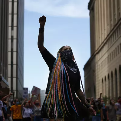 Toy Slaughter raises a fist during a youth-led march against police brutality and environmental racism in Downtown.