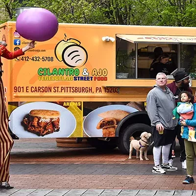 O'Ryan the O'Mazing performs to onlookers by the Cilantro & Ajo food truck during Pittsburgh Opens on Thu., April 21.