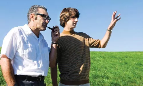 "We'll put the muddy, naked people here": Max Yasgur (Eugene Levy) and Elliot Teichberg (Demetri Martin)