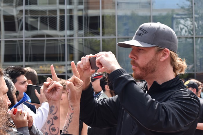 An Infowars guy films an anti-Trump protester, who is not pleased