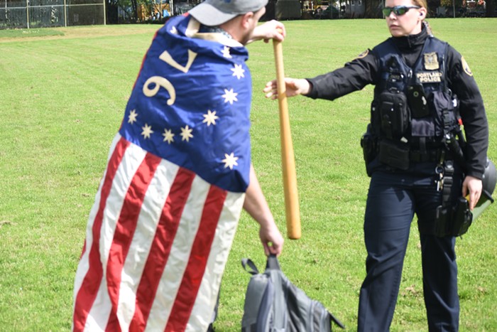 A police officer taking his bat