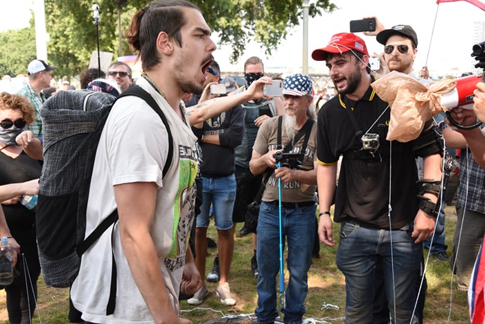 The protester on the left was yelling Native pride at the Proud Boys