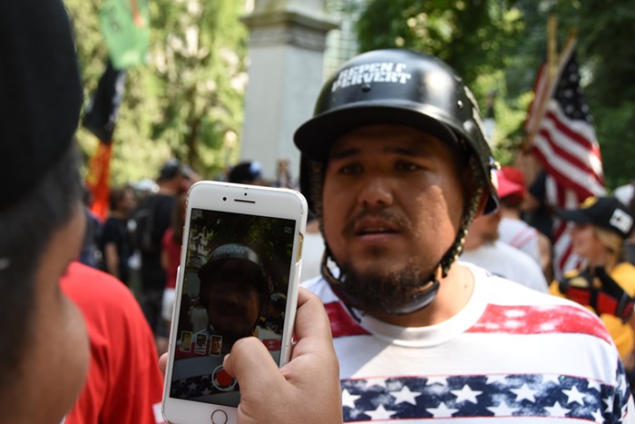 A protester recording a right wing street preacher