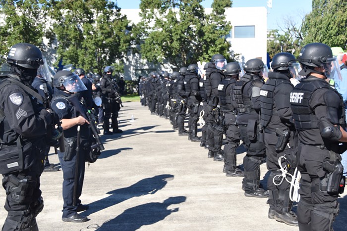 Lines of riot cops separating protesters from Patriot Prayer