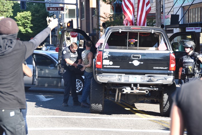 Police quickly cuffed the guy. Hes got a Confederate flag sticker on his back window