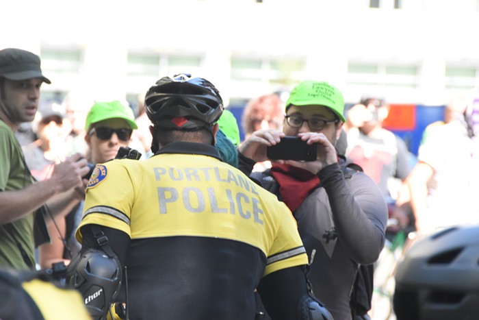 The National Lawyers Guild legal observer just before he was shoved to the ground Sunday