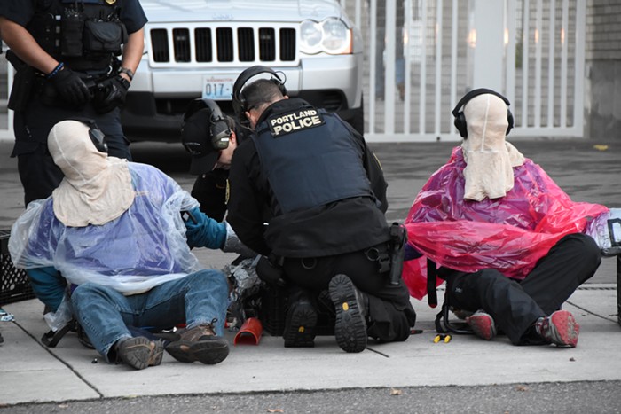 Portland police put hoods and headphones on protesters while separating them, with small hand tools, from the device connecting them