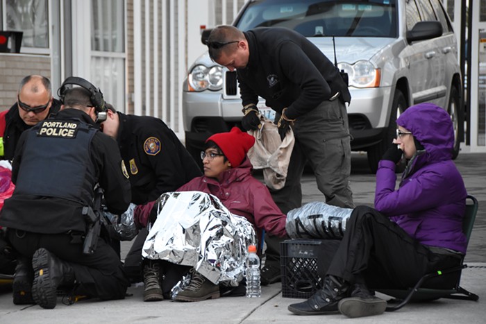 Portland police put a hood and headphones on a fourth protester