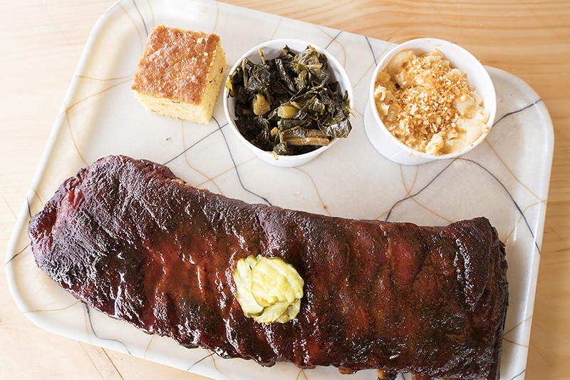 The Duroc pork ribs are cut St. Louis-style and served here with cracklin corn bread, collard greens and mac'n'cheese. - MABEL SUEN
