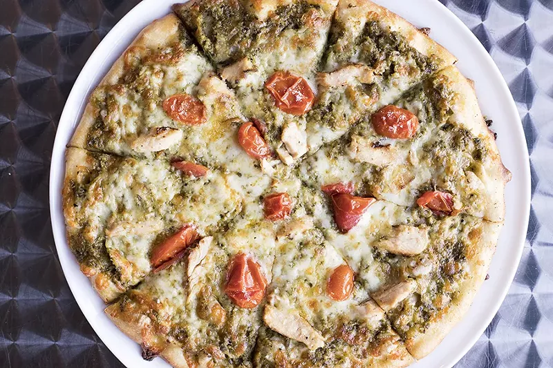 The chicken pesto pizza is topped with basil pesto sauce, cherry tomato and grilled chicken. - MABEL SUEN