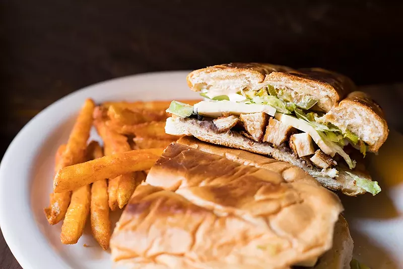 The Milanesa torta includes breaded chicken, refried beans, avocado, lettuce, tomato, onions, jalapenos, queso fresco and chipotle crema. - MABEL SUEN